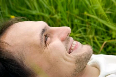 The man lies on a grass Stock Photos