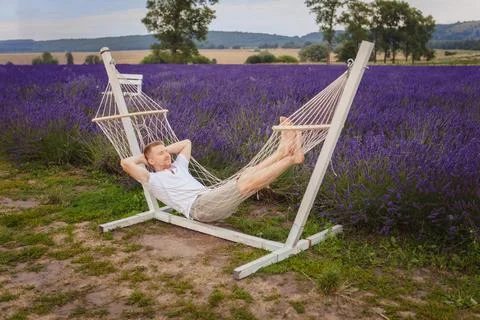 A man lies in a hammock Stock Photos