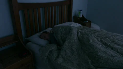 A man lies sick in bed and throws up Stock Footage 33581283