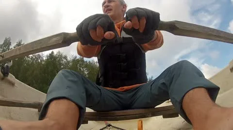 Man in a Life Jacket in a Boat Rowing Oars, closeup Stock Footage 11548026