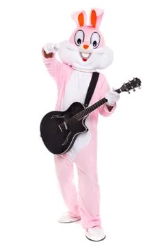 Man in life size easter bunny costume plays music on guitar. Funny hare or Stock Photos