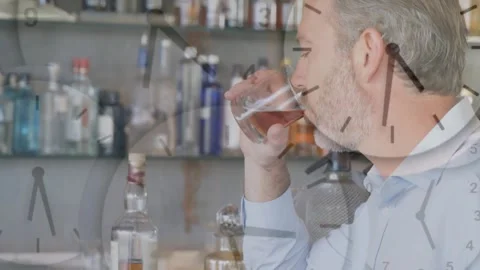 Man lifting and sampling whiskey at bar with shelving while clock overlay Stock Footage 328224769