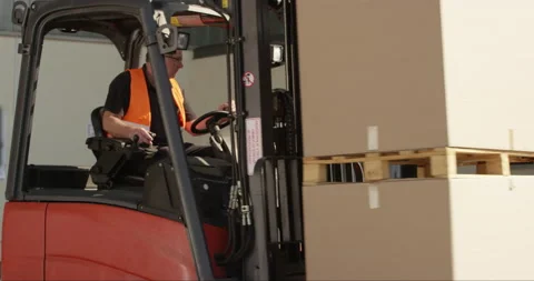 Man Lifting Boxes With Forklift Stock Footage 142891249
