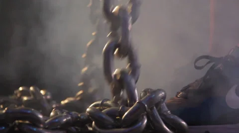 Man Lifting Chains in Smoke Stock Footage 32398973