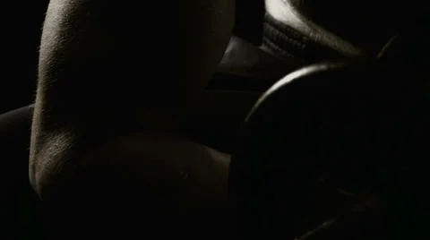 Man lifting dumbells and sweating while sitting down Stock Footage 33831288