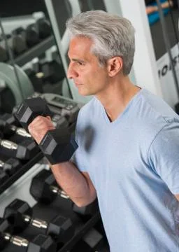 Man lifting free weights at the gym Stock Photos
