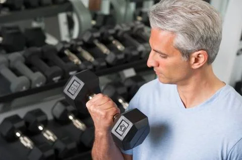 Man lifting free weights at the gym Stock Photos