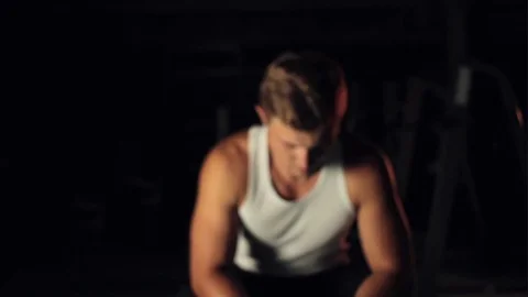 Man lifting up head in darkness 스톡 동영상 77878396