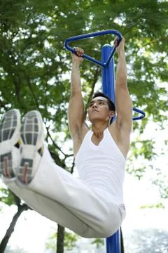 Man lifting himself off the ground Stock Photos