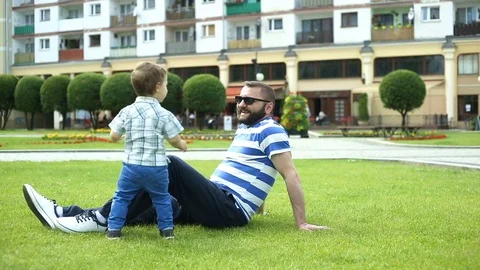 Man lifting his child while having fun in the park Stock Footage 76981314