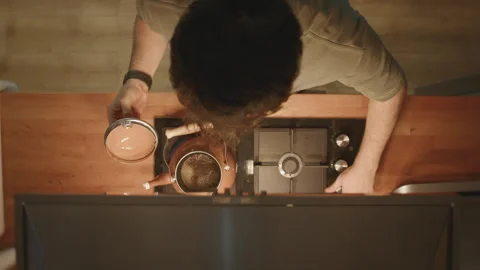 Man lifting lid off copper teapot to check tea brewing on stove, top down vie Stock Footage 344085962