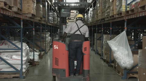 Man on lifting machine in warehouse Stock Footage 62526897