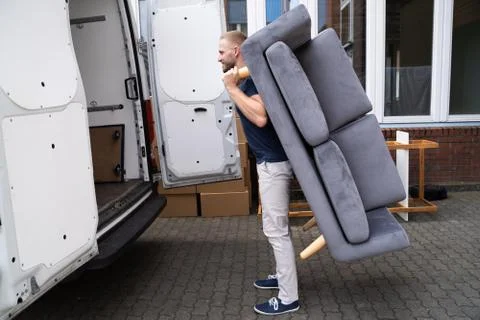 Man Lifting Sofa Or Couch Furniture Stock Photos
