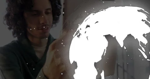 Man lifting tablet and tapping, rotating transparent globe and exploring global Stock Footage 311084043