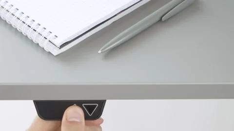 The man lifts up a desk of variable height for standing work Stock Footage 157318926