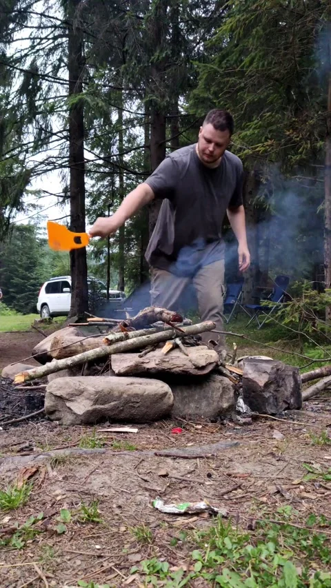 Man light a bonfire at campsite Stock Footage 160966339