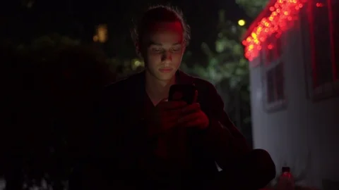 Man lighted of red light use smartphone on the street at night 11 Видео 95860909