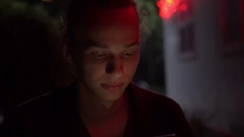 Man lighted of red light use smartphone on the street at night 2 Stockbeeldmateriaal 95864079