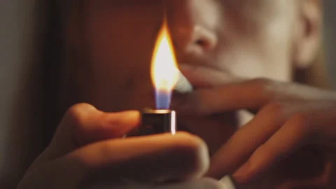 Man with Lighter in Hand Lighting a Join in Slow Motion Video stock 150087506