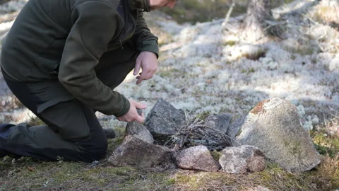 Man Lighting Campfire in Forest Fire Starting Survival Skills 库存影片 332720605
