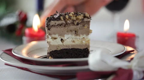 Man lighting a candle on christmas table. Focus on cake Stock Footage 42186687