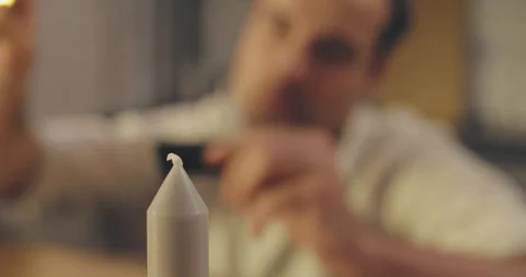 Man lighting up candle Stock Footage 114116005
