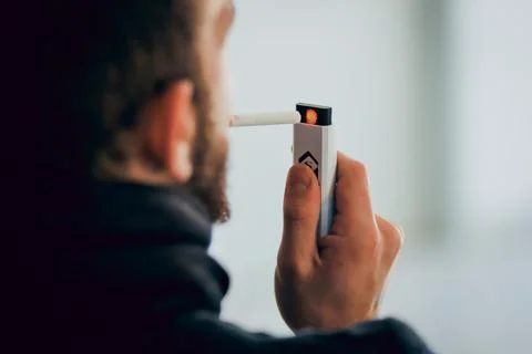 Man lighting cigarette with electronic lighter Foto stock