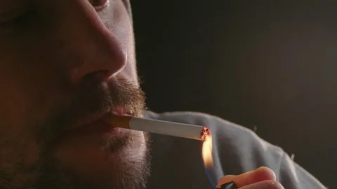 Man lighting up a cigarette with a lighter Stock Footage 168027772