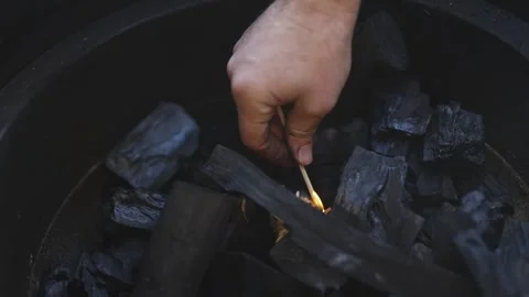 A man is lighting a cigarette with a match Video stock 295369072