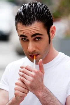 Man lighting cigarette Stock Photos