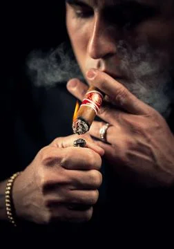 Man Lighting a Cuban Cigar Stock Photos
