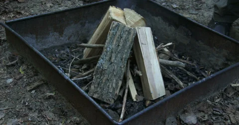 Man lighting fire on camp site Stock Footage 39299726