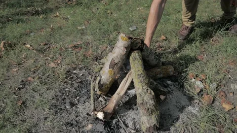 Man lighting a fire in a meadow Stock Footage 192897251