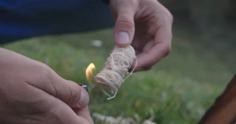 Man lighting a fire starter for a campfire Stock Footage 230409344
