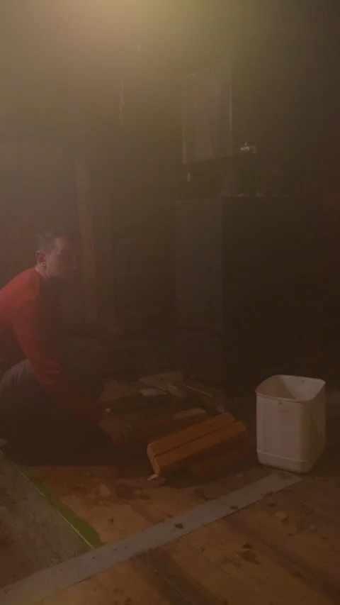 Man lighting a fire in a traditional sauna stove Stock Footage 337933810