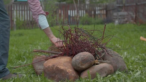 Man lighting a fire in the yard Stock Footage 130810603