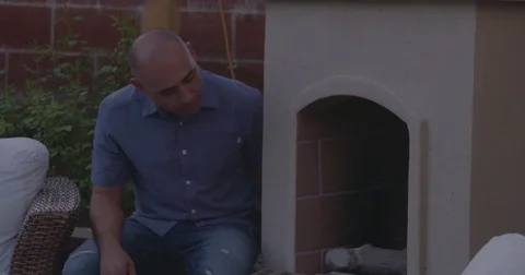 Man lighting the fireplace at evening Stock Footage 83187059