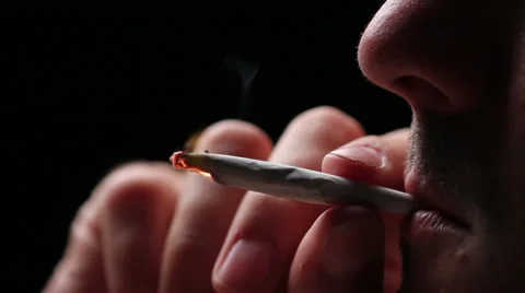 Man lighting a joint, close up on black Stock Footage 7822931