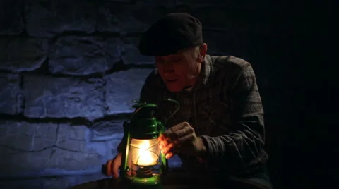 Man lighting an old oil lamp in darkness Stock Footage 45183162