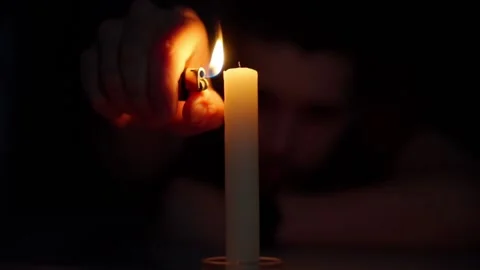 A man lights a candle Stock Footage 199092619