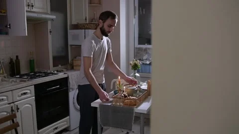 Man lights candles and picks up a breakfast tray 库存影片 330128662