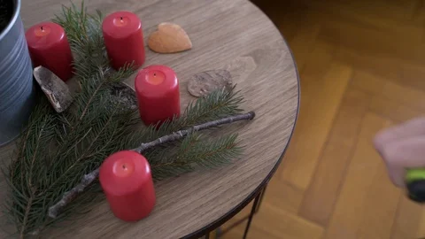 Man lights up candles on bedside table with authentic Chrismas decoration. Stock Footage 102657654