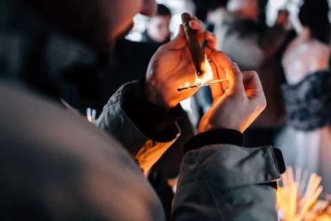 A man lights a cigar Stock Photos