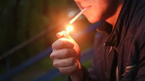 The man lights a cigarette and smokes Stock Footage 131339554