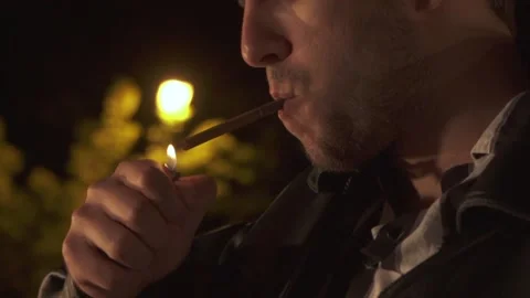Man lights up a cigarette 스톡 동영상 155844617
