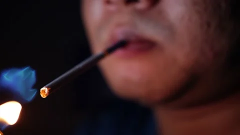 Man lights cigarette with lighter Stock Footage 221459428