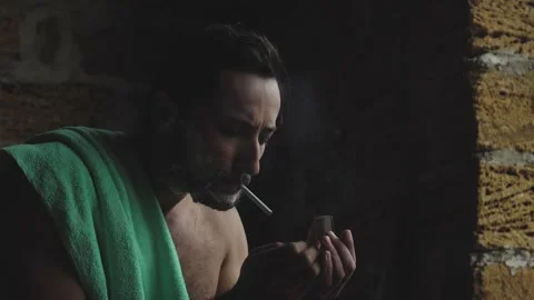 A man lights a cigarette while shaving and talks Stock Footage 160393102
