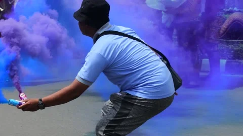 A man lights colored smoke during traditional dance performance in Central Stock Footage 237064748