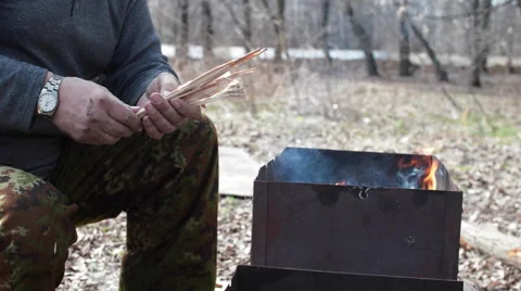 Man Lights the Fire in the Grill Stock Footage 62417229