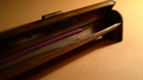 A man lights a incense stick mounted in a bamboo holder Video stock 128871103